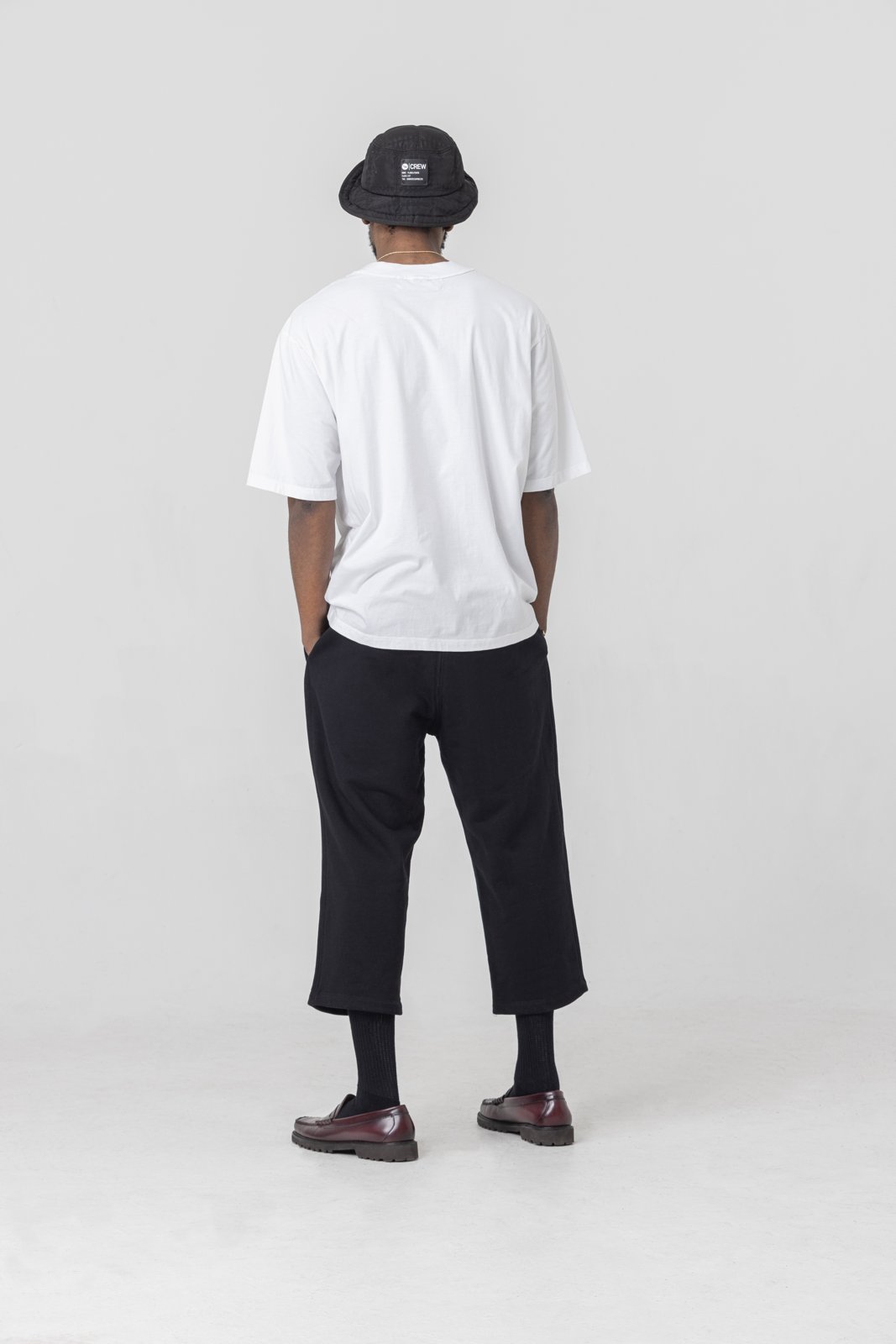 Black cropped sweatpants — back view on model