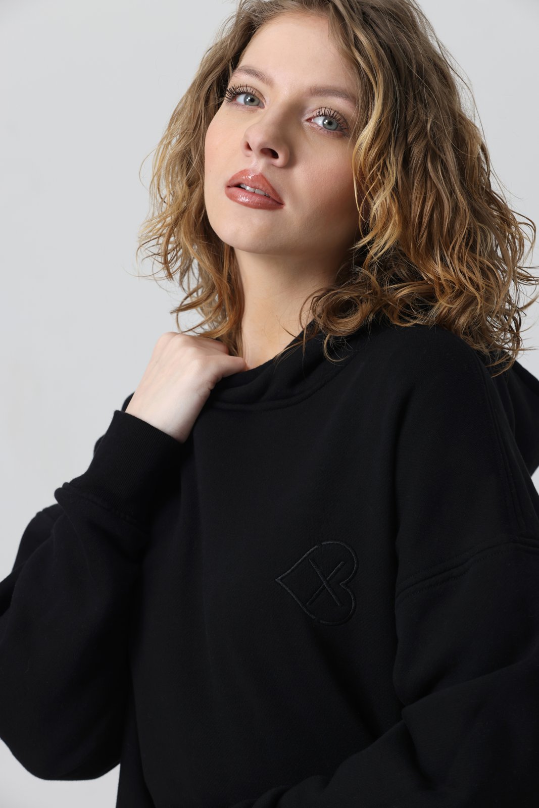 Oversized black hoodie — hood and tonal chest embroidery