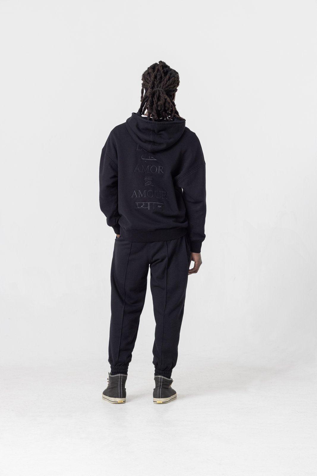 Oversized black hoodie — back view on model