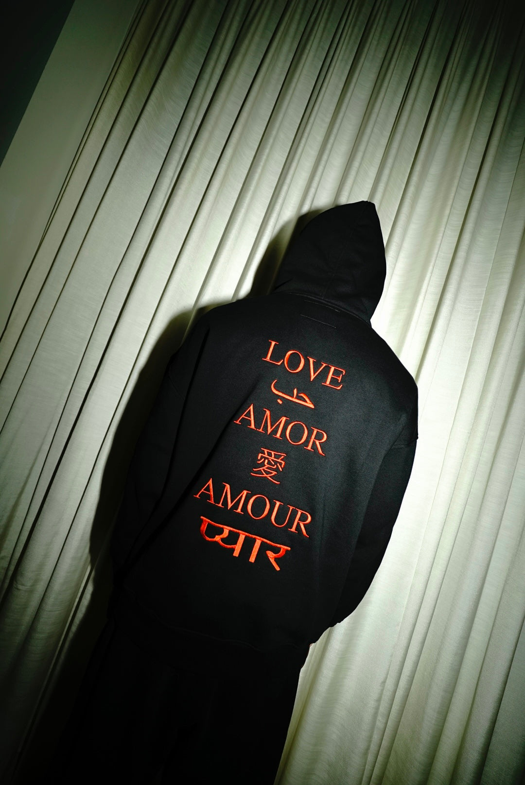Red multilingual love embroidery on the back of the LX3 hoodie