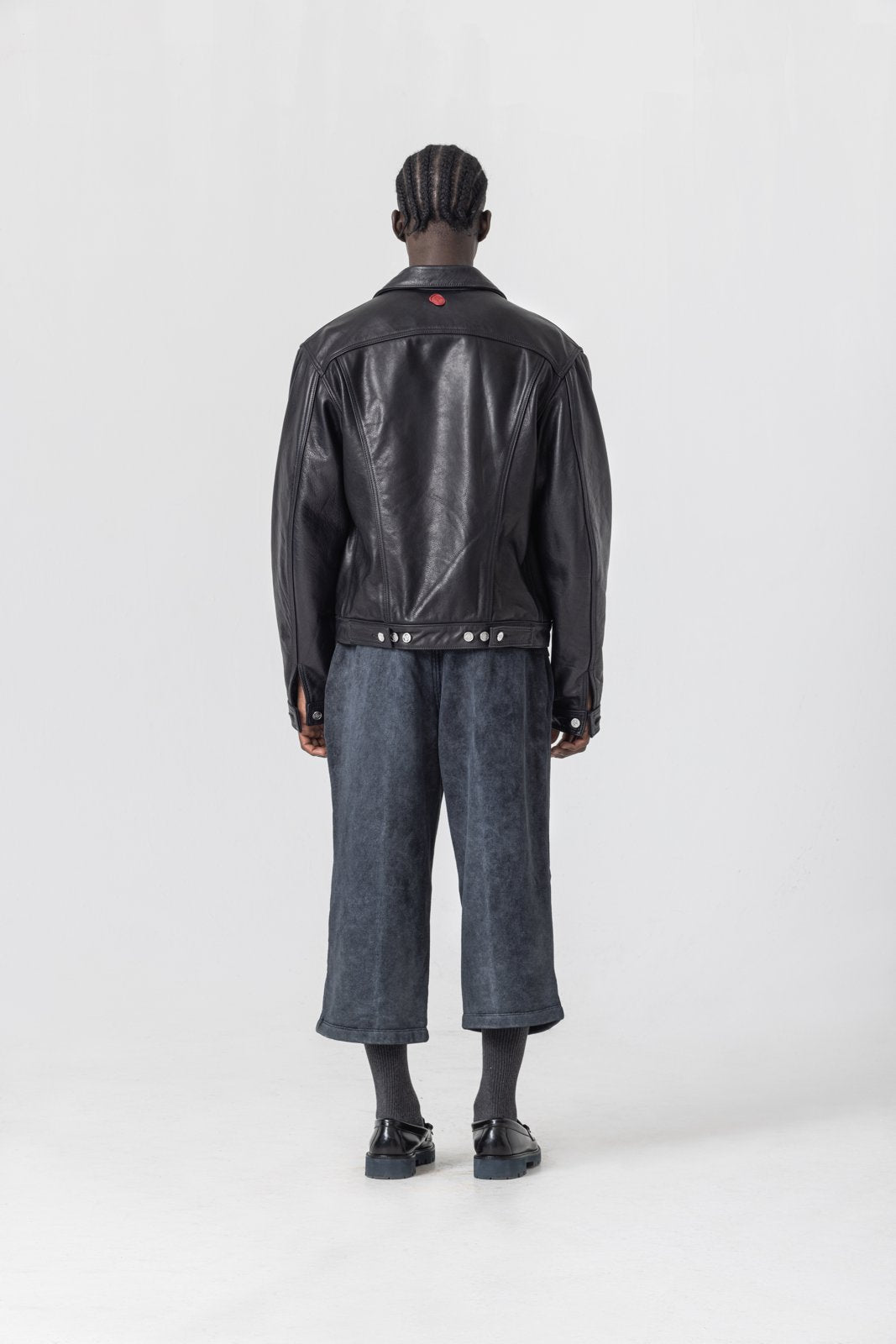 Leather trucker jacket — back view on model