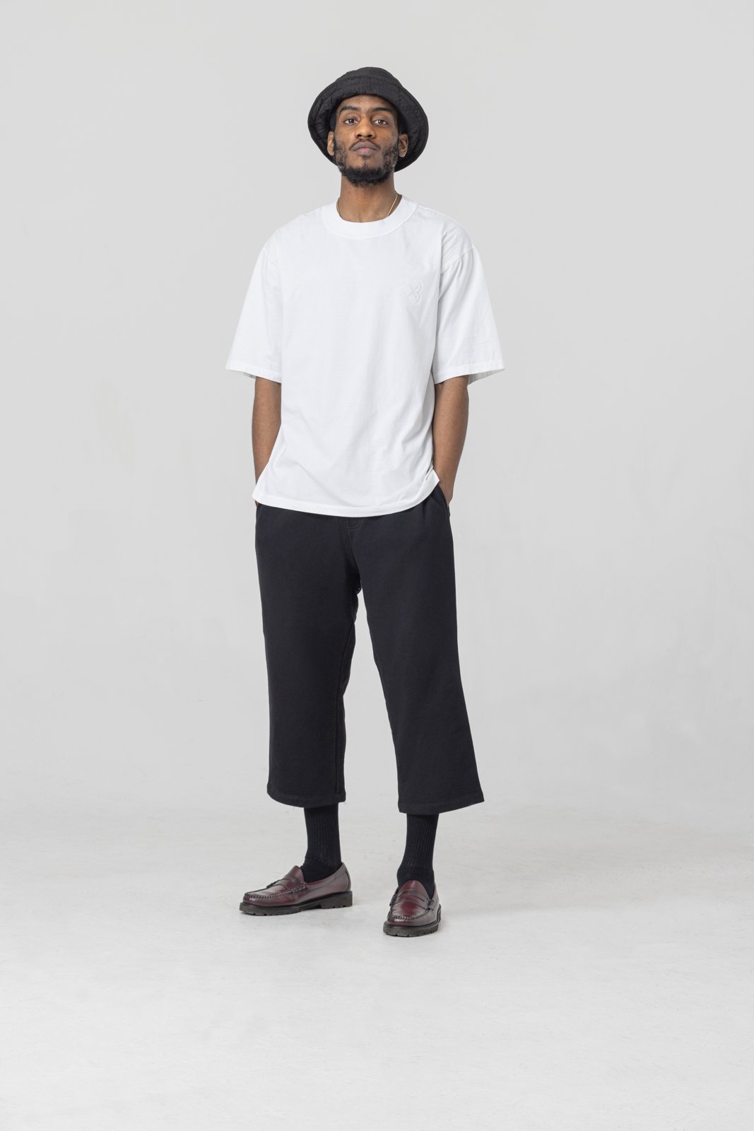 Black cropped sweatpants — front view on model