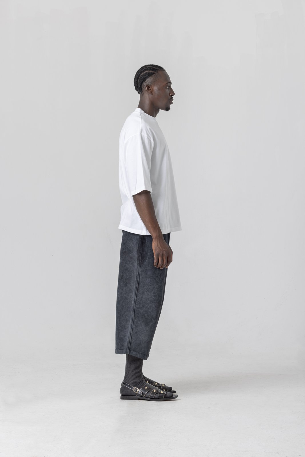 White mock neck tee — side profile showing neckline and hem